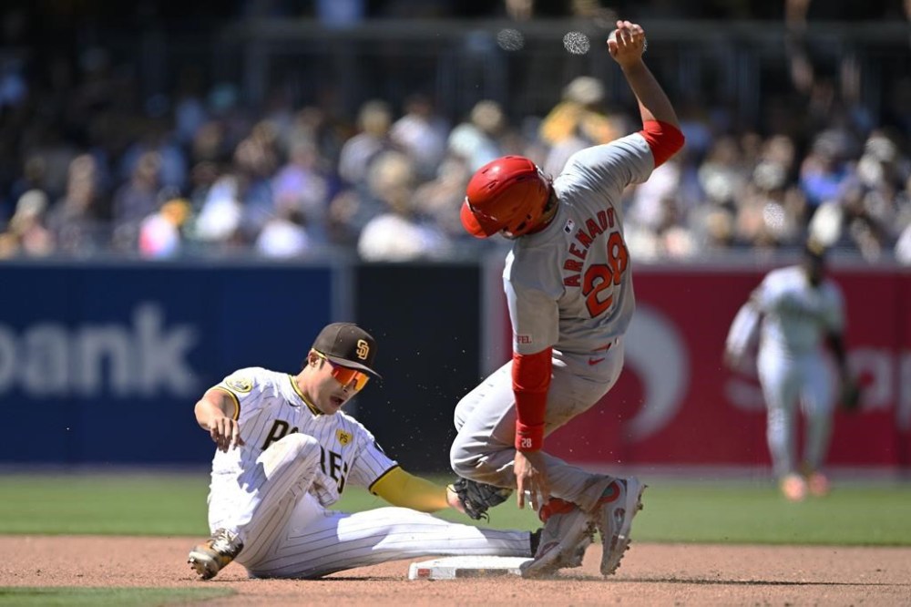 St. Louis Cardinals' Nolan Arenado (28) is tagged out at second base by San Diego Padres shortstop Ha-Seong Kim (7) as he tries to steal during the fourth inning of a baseball game, Wednesday, April 3, 2024, in San Diego. (AP Photo/Denis Poroy)