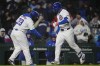 Chicago Cubs' Seiya Suzuki, right, slaps hands with third base coach Willie Harris as runs the bases after hitting a home run against the Colorado Rockies during the fifth inning of a baseball game Wednesday, April 3, 2024, in Chicago. (AP Photo/Erin Hooley)