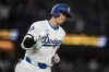Los Angeles Dodgers designated hitter Shohei Ohtani celebrates as he runs the bases after hitting a home run during the seventh inning of a baseball game against the San Francisco Giants in Los Angeles, Wednesday, April 3, 2024. (AP Photo/Ashley Landis)