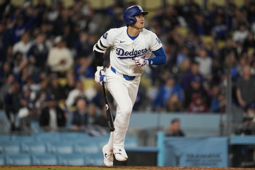 Los Angeles Dodgers designated hitter Shohei Ohtani hits a home run during the seventh inning of a baseball game against the San Francisco Giants in Los Angeles, Wednesday, April 3, 2024. (AP Photo/Ashley Landis)