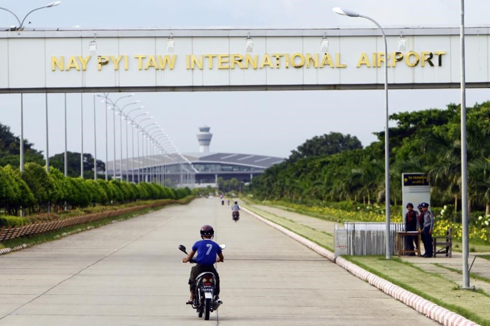 FILE - A resident drives motorbike to Naypyitaw International Airport as security police stand guard, Thursday, Sept. 29, 2016, in Naypyitaw, Myanmar. Myanmar’s main pro-democracy resistance group said Thursday, April 4, 2024, its armed wing launched drone attacks on the airport and a military headquarters in the capital, Naypyitaw, but the country’s ruling military said it destroyed or seized more than a dozen drones used in the attacks. (AP Photo/Aung Shine Oo, File)