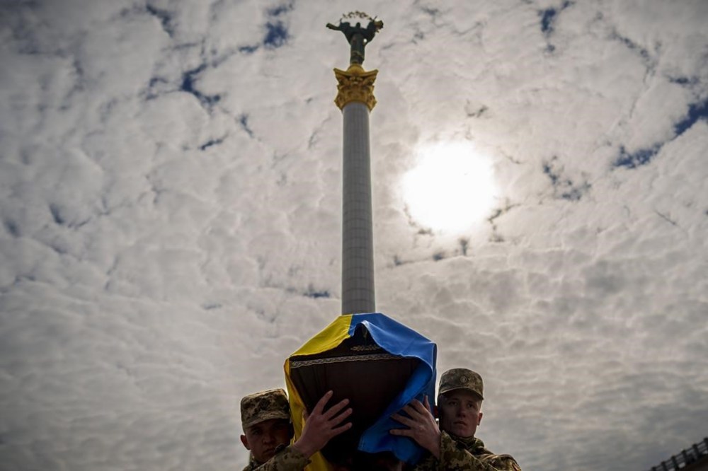 Ukrainian servicemen carry the coffin of their fallen fellow Vadym Popelniuk, born in 1991, during a religious service in Independence Square in Kyiv, Ukraine, Friday, April 5, 2024. (AP Photo/Vadim Ghirda)