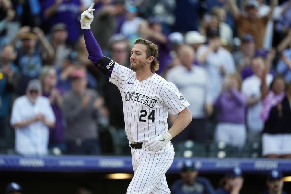 Colorado Rockies' Ryan McMahon gestures as he circles the bases after hitting a walkoff grand slam off Tampa Bay Rays pitcher Jason Adam in the ninth inning of a baseball game Friday, April 5, 2024, in Denver. (AP Photo/David Zalubowski)