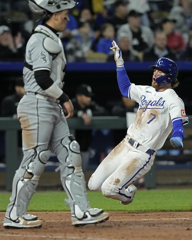 Kansas City Royals' Bobby Witt Jr. (7) slides home past Chicago White Sox catcher Korey Lee to score on a three-run fielder's choice hit into by Salvador Perez during the seventh inning of a baseball game Thursday, April 4, 2024, in Kansas City, Mo. (AP Photo/Charlie Riedel)