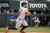 Houston Astros' Jose Altuve connects for a single in the first inning of a baseball game against the Texas Rangers in Arlington, Texas, Friday, April 5, 2024. (AP Photo/Tony Gutierrez)