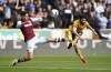 Wolverhampton Wanderers' Rayan Ait-Nouri, right, shoots past West Ham United's Edson Alvarez during the English Premier League soccer match between West Ham United and Wolverhampton Wanderers at Molineux stadium in Wolverhampton, England, Saturday April 6, 2024. (Mike Egerton/PA via AP)