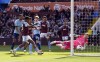 Aston Villa's Ollie Watkins, second left, scores his side's first goal of the game , during the English Premier League soccer match between Aston Villa and Brentford, at Villa Park, in Birmingham, England, Saturday April 6, 2024. (Nick Potts/PA via AP)