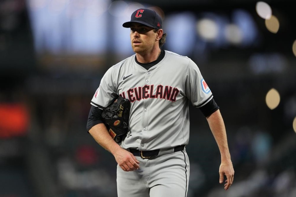 FILE - Cleveland Guardians starting pitcher Shane Bieber walks back to the dugout after throwing against the Seattle Mariners in a baseball game Tuesday, April 2, 2024, in Seattle. Cleveland's ace will have season-ending Tommy John elbow surgery, a major blow to the Guardians and the 2020 Cy Young winner, who had looked like his dominant self in two strong recent starts. (AP Photo/Lindsey Wasson, File)