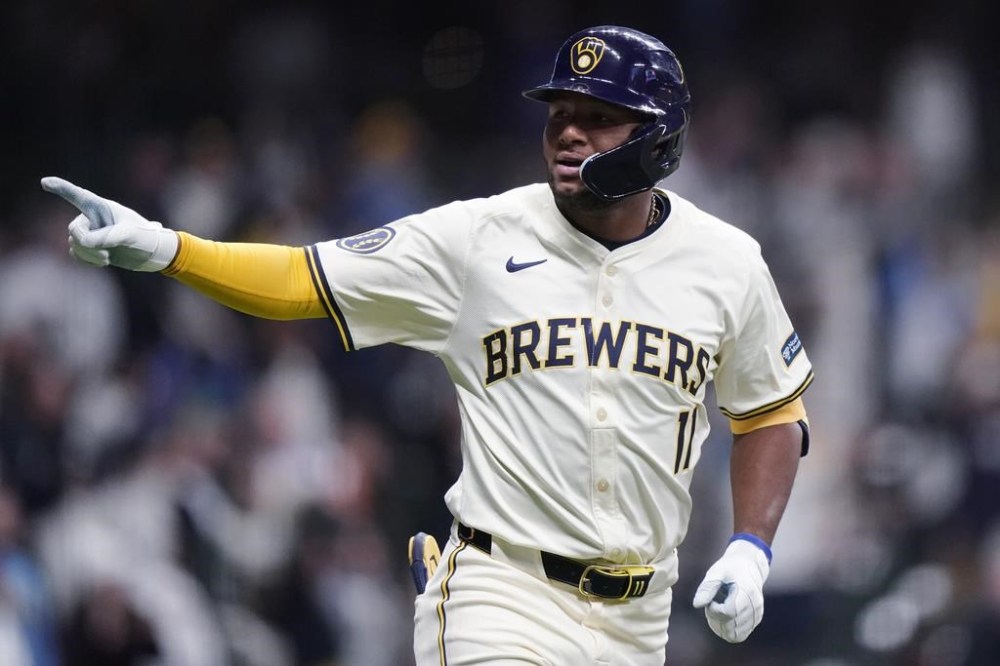 Milwaukee Brewers' Jackson Chourio gestures to the dugout after hitting a two-run home run during the eighth inning of the team's baseball game against the Seattle Mariners on Saturday, April 6, 2024, in Milwaukee. (AP Photo/Aaron Gash)
