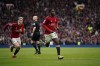 Manchester United's Kobbie Mainoo, centre, celebrates after scoring his side's second goal during the English Premier League soccer match between Manchester United and Liverpool at the Old Trafford stadium in Manchester, England, Sunday, April 7, 2024. (AP Photo/Dave Thompson)