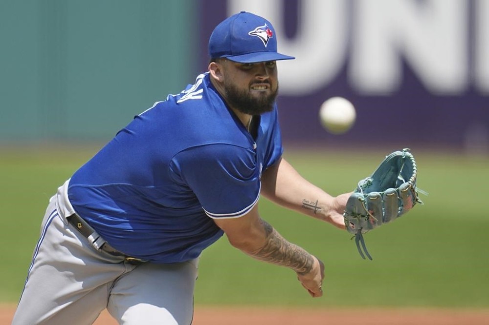 FILE - Toronto Blue Jays' Alek Manoah pitches in the first inning of a baseball game against the Cleveland Guardians Thursday, Aug. 10, 2023, in Cleveland. Toronto Blue Jays right-hander Alek Manoah was happy with his first minor league rehab start despite an ugly line because his right shoulder felt healthy. Manoah walked his first four batters and wound up allowing seven runs over 1 2/3 innings for Single A Dunedin against Lakeland in a Florida State League game on Sunday, April 7, 2024. (AP Photo/Sue Ogrocki, File)