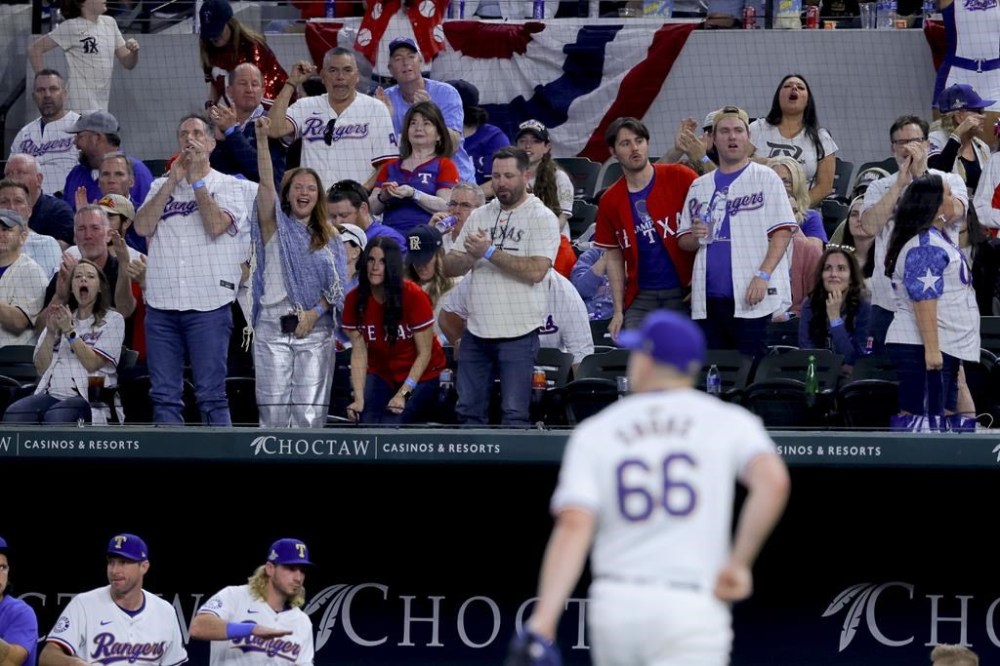 Texas Rangers relief pitcher Josh Sborz (66) walks off the field after striking out Chicago Cubs' Yan Gomes to end the seventh inning of a baseball game Thursday, March 28, 2024 in Arlington, Texas. (AP Photo/Gareth Patterson)
