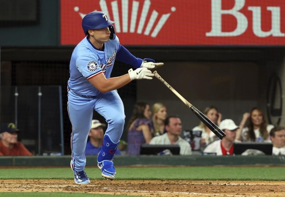 Texas Rangers' Justin Foscue (56) runs to first after hitting an RBI single in the ninth inning of a baseball game against the Houston Astros Sunday, April 7, 2024, in Arlington, Texas. (AP Photo/ Richard W. Rodriguez)