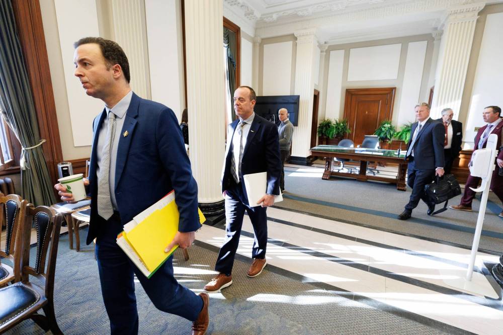 MIKE DEAL / FREE PRESs fileS
Finance Minister Adrien Sala (left), followed by Manitoba Hydro interim CEO Hal Turner, arrive at the legislature committee on Crown corporations Feb. 22.