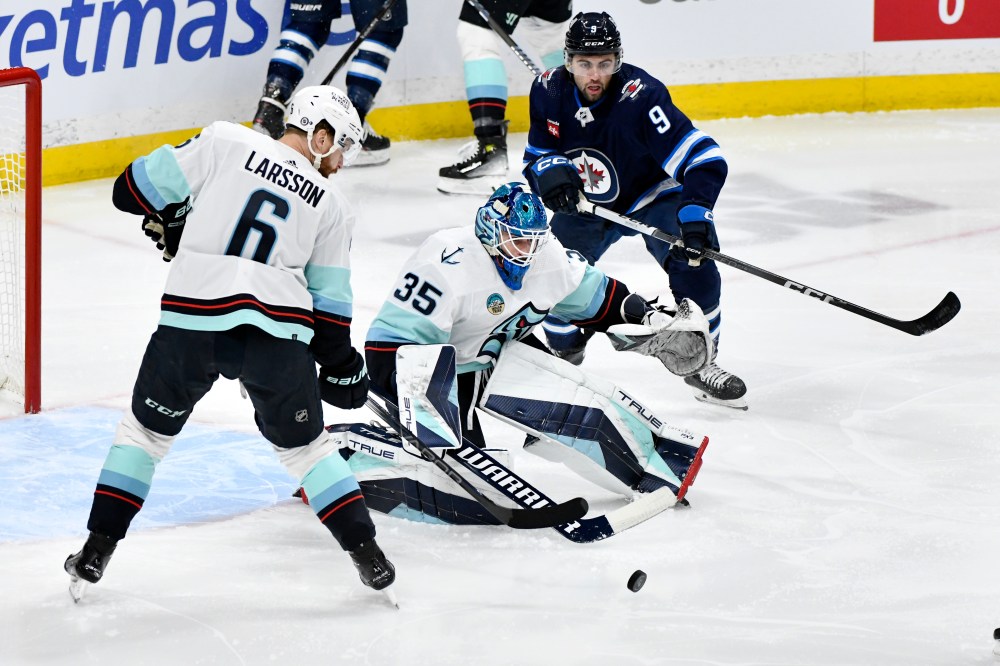 Fred Greenslade / THE CANADIAN PRESS
Seattle Kraken goaltender Joey Daccord makes a save on a Winnipeg Jets shot as Adam Larsson and Alex Iafallo look for the rebound during the first period.
