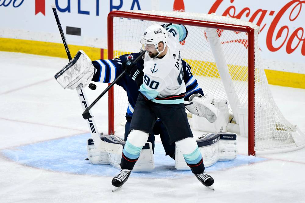 Fred Greenslade / THE CANADIAN PRESS
Seattle’s Tomas Tatar tips the puck past Jets goaltender Connor Hellebuyck to tie the game early in the third period.