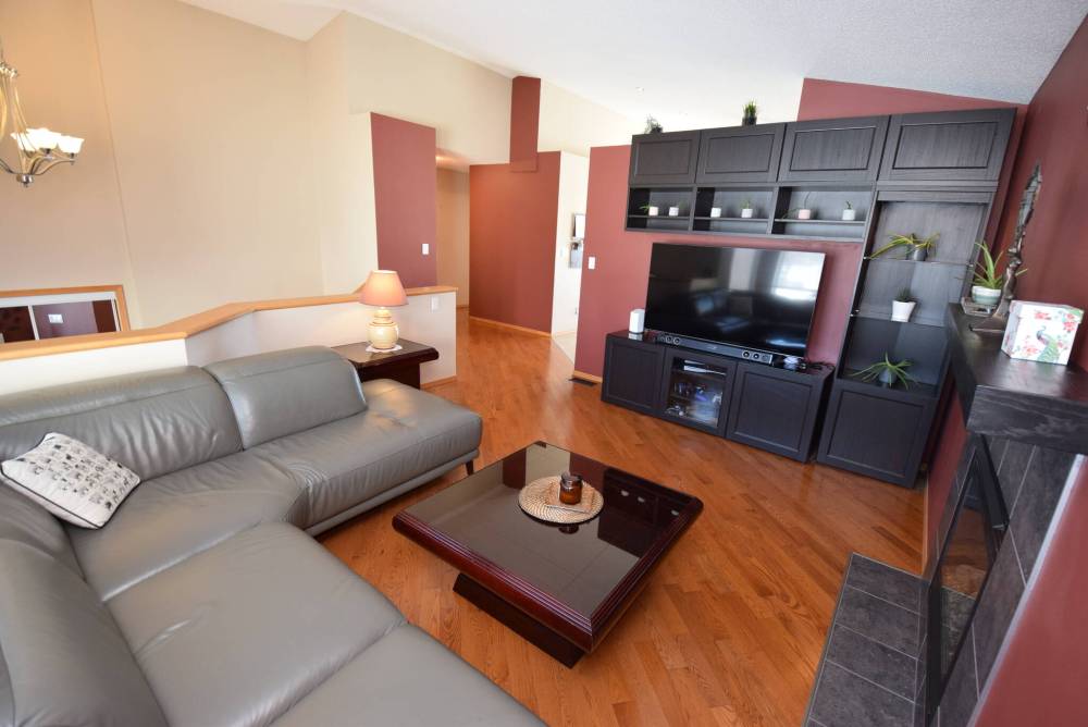 The living room offers oak hardwoods and a gas fireplace.