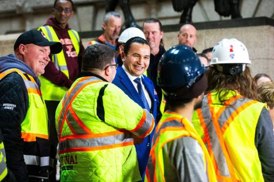 Premier Wab Kinew greets union members at a news conference announcing a bid to repeal a ban on project labour agreements. (Mikaela MacKenzie / Winnipeg Free Press)