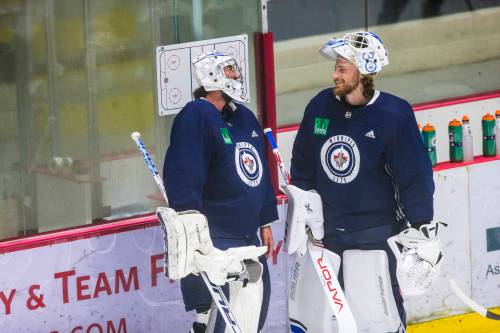 MIKAELA MACKENZIE / WINNIPEG FREE PRESS Goalies Connor Hellebuyck (left) and Laurent Brossoit chat at Jets training camp at the Bell MTS Iceplex in Winnipeg on Friday, July 17, 2020. For Mike McIntyre story. Winnipeg Free Press 2020.
                                MIKAELA MACKENZIE / FREE PRESS
                                Goalies Connor Hellebuyck (left) and Laurent Brossoit chat at Jets training camp at the Bell MTS Iceplex in 2020.