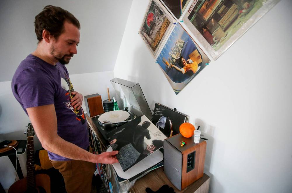 JOHN WOODS / FREE PRESS
                                Soloway checks a record’s details as he puts an LP on the turntable at a monthly record club meeting.