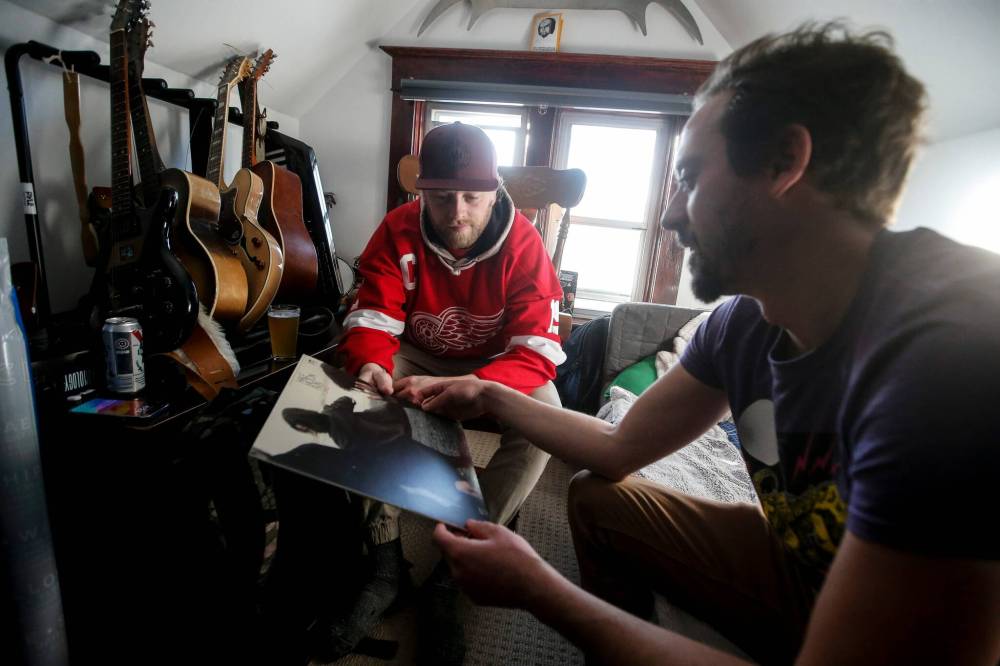 Photos by JOHN WOODS / FREE PRESS
                                Sean Soloway, right, talks with Garrett Wellwood about his contribution at the monthly record club meeting at Soloway’s home last month.