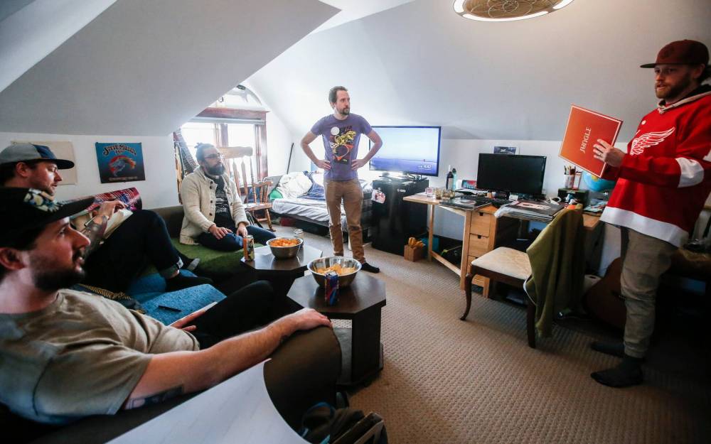 JOHN WOODS / FREE PRESS
                                Sean Gutheil, from left, Jordan Bodnar, Danny Lütz, Garrett Wellwood and Sean Soloway talk and listen to records at their monthly record club in Soloway’s house Sunday, February 18, 2024. It is the fifth anniversary of the club.