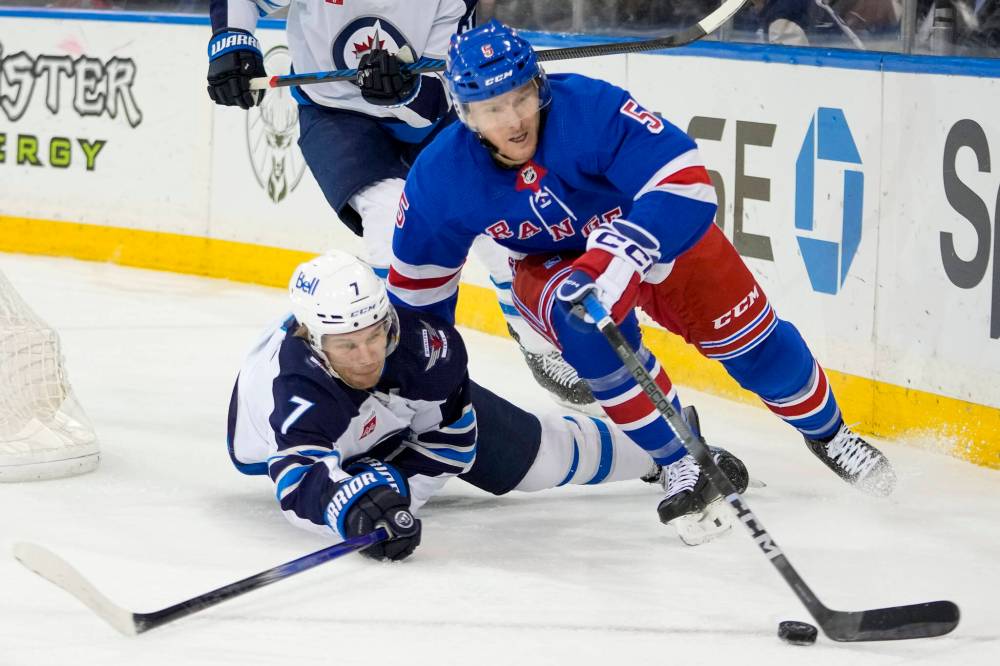 Mary Altaffer / The Associated Press
New York Rangers defenceman Chad Ruhwedel skates away from Winnipeg Jets centre Vladislav Namestnikov during the first period.