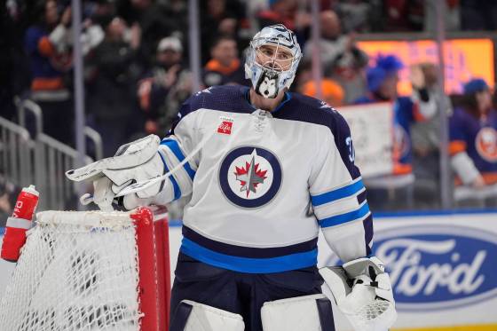 FRANK FRANKLIN II / THE ASSOCIATED PRESS Jets goaltender Connor Hellebuyck reacts after a goal by Mathew Barzal in the second period Saturday. Hellebuyck was pulled after the goal.