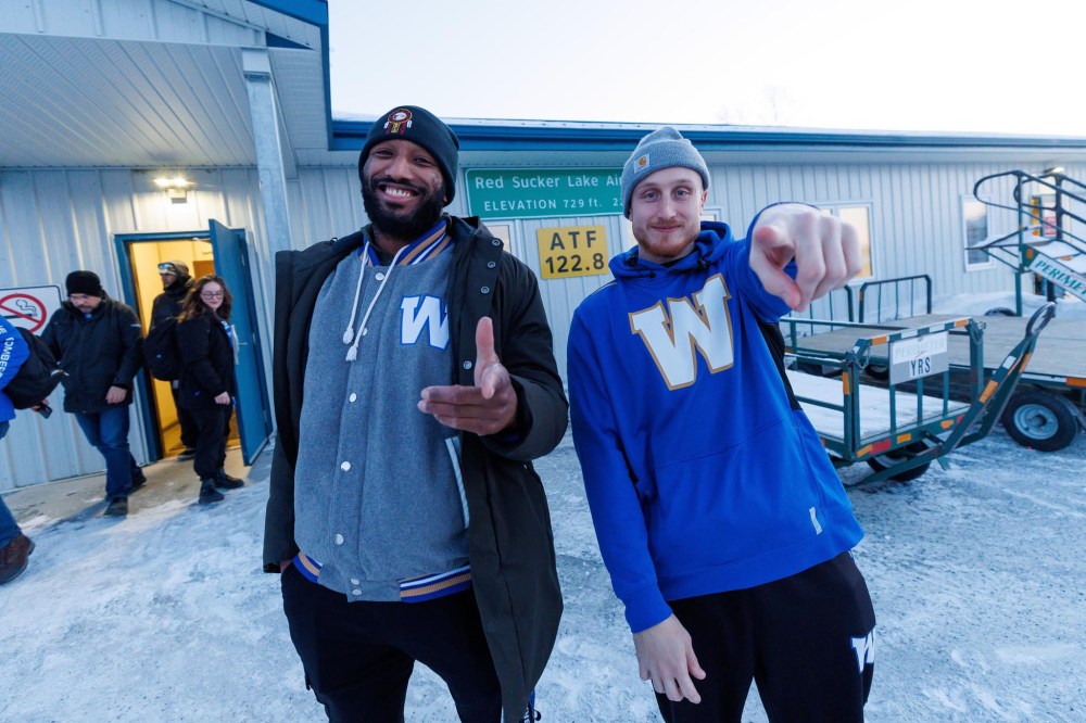 MIKE DEAL / FREE PRESS
Bombers Brandon Alexander (left) and Nick Hallett outside the Red Sucker Lake airport.