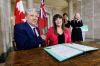 MIKE DEAL / FREE PRESS Northern Affairs Minister Dan Vandal and Minister Housing, Addictions and Homelessness Bernadette Smith sign documents during an announcement by the federal government and Manitoba governments that states they’ve earmarked a combined $27.5 million to help gender based violence survivors find home.