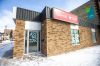 MIKAELA MACKENZIE / FREE PRESS Graffiti reads “axe the tax” and “spike the hike” on the windows and doors of the Manitoba Liberal Party office on Broadway on Wednesday, March 27, 2024.