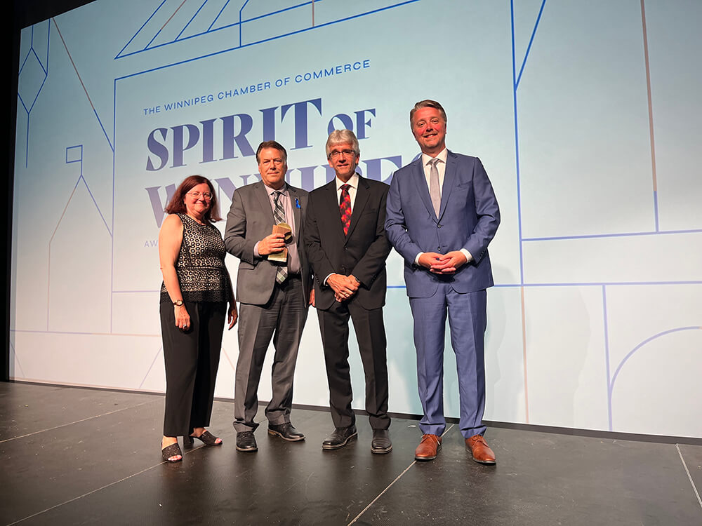 Kevin Sitka (third from the left), CEO at Assiniboine Credit Union, accepting a Chamber of Commerce Spirit of Winnipeg award.