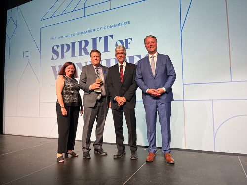 Kevin Sitka (third from the left), CEO at Assiniboine Credit Union, accepting a Chamber of Commerce Spirit of Winnipeg award.