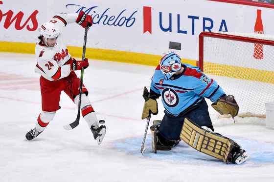 Carolina Hurricanes' Seth Jarvis (24) attempts a shot on Winnipeg Jets goaltender Laurent Brossoit (39) during first period NHL action in Winnipeg on December 4, 2023. (Fred Greenslade / The Canadian Press)