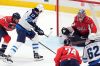 Winnipeg Jets center Adam Lowry (17) shoots against Washington Capitals goaltender Charlie Lindgren (79) in the third period of an NHL hockey game, Sunday, March 24, 2024, in Washington. (AP Photo/Mark Schiefelbein)