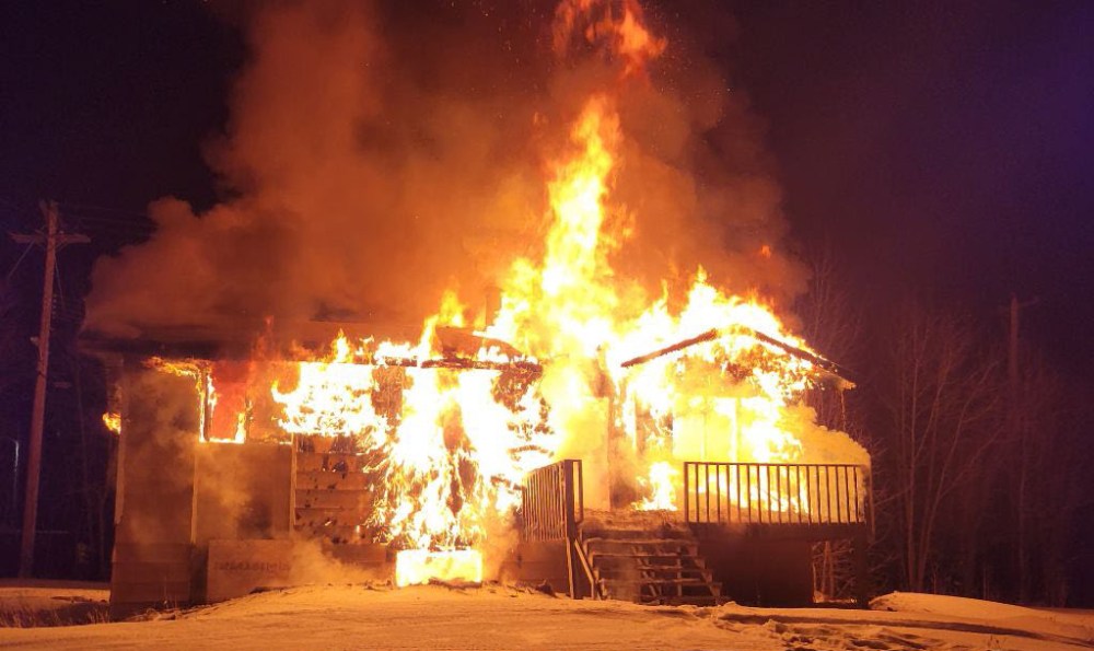 A home burns in Gods Lake Narrows on Saturday. (Supplied)