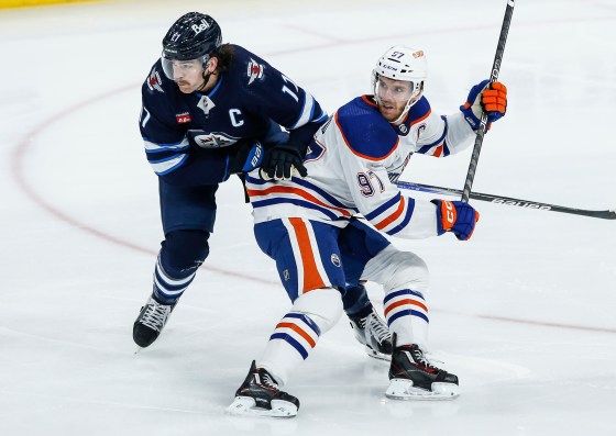 Winnipeg Jets' Adam Lowry and Edmonton Oilers' Connor McDavid collide back in November. Fans wait to see how the Jets will respond to losing three consecutive games. (John Woods / The Canadian Press files)