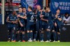 Bochum's scorer Philipp Hofmann, sixth from left, and his teammates celebrate their side's second goal during the Bundesliga soccer match between VfL Bochum and SV Darmstadt 98 in Bochum, Germany, Sunday, March 31, 2024. (David Inderlied/dpa via AP)