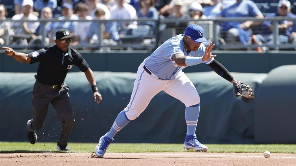 Kansas City Royals first baseman Salvador Perez goes after a misplayed ground ball hit by Chicago White Sox' Robbie Grossman during the first inning of a baseball game in Kansas City, Mo., Sunday, April 7, 2024. Grossman was out on the play. (AP Photo/Colin E. Braley)