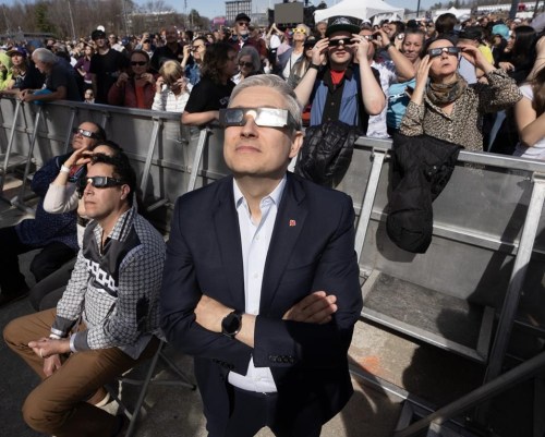 Federal Minister of Science and Industry Francois-Philippe Champagne watches the total solar eclipse at Parc Jean Drapeau, in Montreal, Monday, April 8, 2024. Champagne's colleagues in Ottawa also paused the business of government briefly to take in the show. THE CANADIAN PRESS/Ryan Remiorz