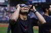 Cleveland Guardians second baseman Andrés Giménez uses special glasses to watch the total solar eclipse, Monday, April 8, 2024, in Cleveland. (AP Photo/Ron Schwane)