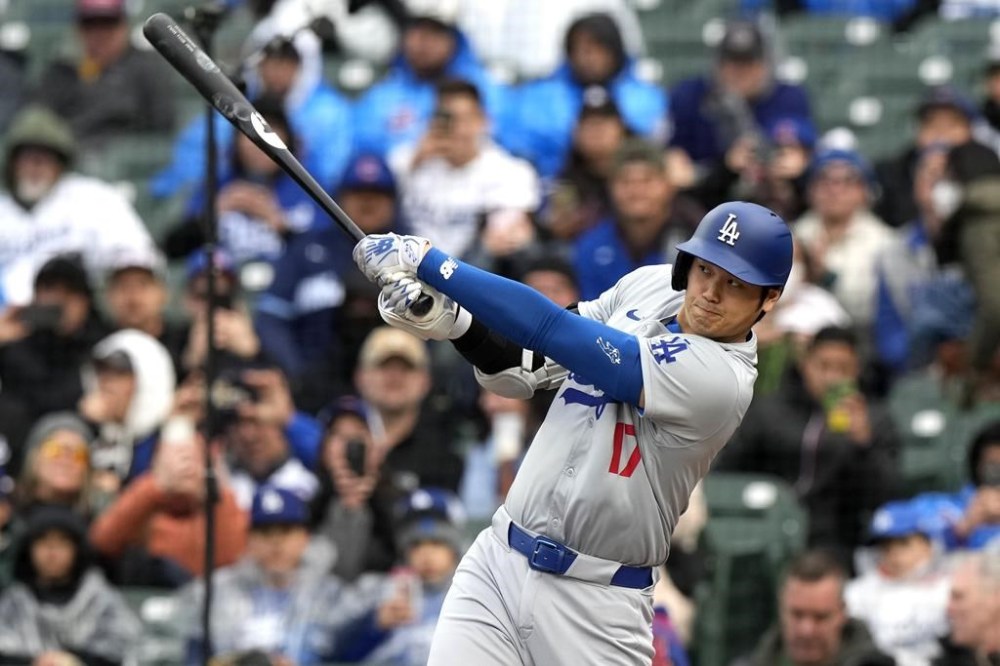 Los Angeles Dodgers' Shohei Ohtani, of Japan, hits a triple during the sixth inning of a baseball game against the Chicago Cubs in Chicago, Sunday, April 7, 2024. (AP Photo/Nam Y. Huh)
