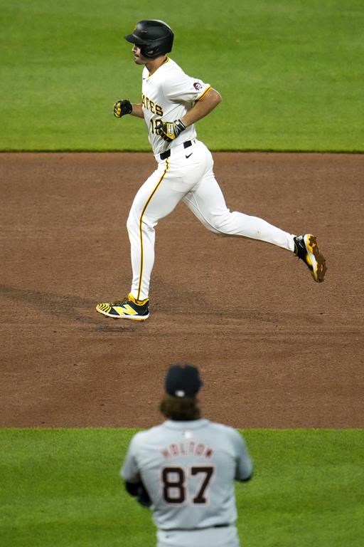 Pittsburgh Pirates' Bryan Reynolds, top, rounds the bases after hitting a solo home run off Detroit Tigers relief pitcher Tyler Holton (87) during the sixth inning of a baseball game in Pittsburgh, Monday, April 8, 2024. (AP Photo/Gene J. Puskar)
