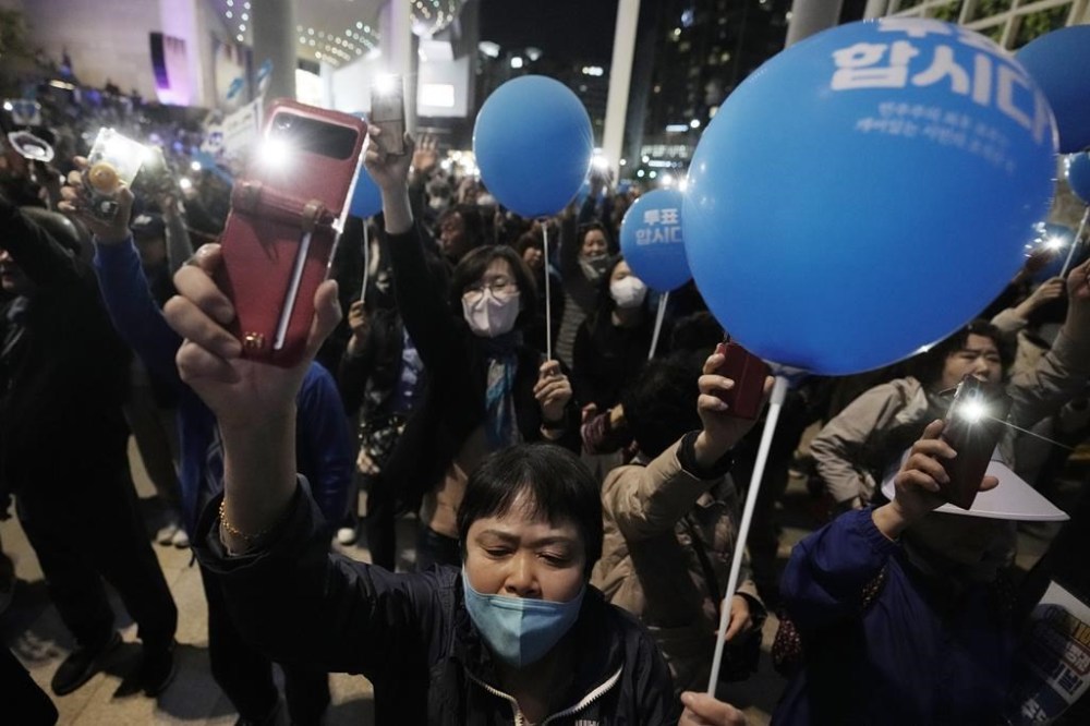 Supporters of main opposition Democratic Party cheer during the party's parliamentary election campaign in Seoul, South Korea, Tuesday, April 9, 2024. The parliamentary election will be held on April 10. (AP Photo/Ahn Young-joon)