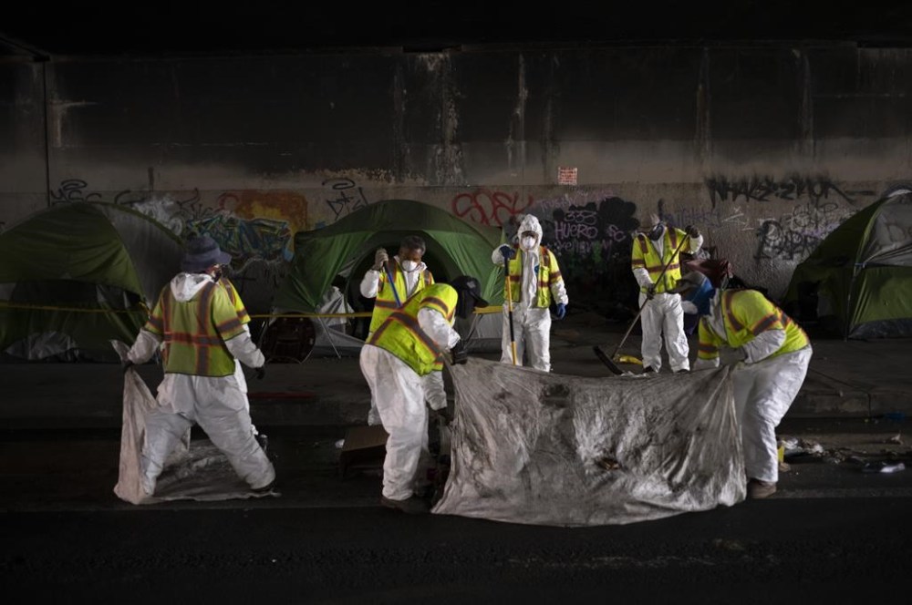 FILE - Los Angeles city employees clean up a homeless encampment to relocate homeless individuals into temporary housing as part of Los Angeles Mayor Karen Bass' Inside Safe program in Los Angeles, Tuesday, Oct. 24, 2023. A state audit has found that California spent $24 billion to tackle homelessness over a five year period but didn’t consistently track the outcomes or effectiveness of its programs. The report released Tuesday, April 9, 2024, attempts to assess how effective the state and local cities have been spending billions of dollars to address the ongoing homelessness crisis in California. (AP Photo/Jae C. Hong, File)