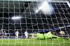 Real Madrid's goalkeeper Andriy Lunin is beaten by Manchester City's Bernardo Silva scoring his side's first goal during the Champions League quarterfinal first leg soccer match between Real Madrid and Manchester City at the Santiago Bernabeu stadium in Madrid, Spain, Tuesday, April 9, 2024. (AP Photo/Manu Fernandez)