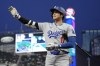 Los Angeles Dodgers designated hitter Shohei Ohtani gestures while walking back to the dugout after striking out to end the top of the sixth inning of a baseball game against the Minnesota Twins, Tuesday, April 9, 2024, in Minneapolis. (AP Photo/Abbie Parr)