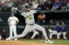 Oakland Athletics relief pitcher Mitch Spence throws to a Texas Rangers batter during the seventh inning of a baseball game in Arlington, Texas, Tuesday, April 9, 2024. (AP Photo/Tony Gutierrez)