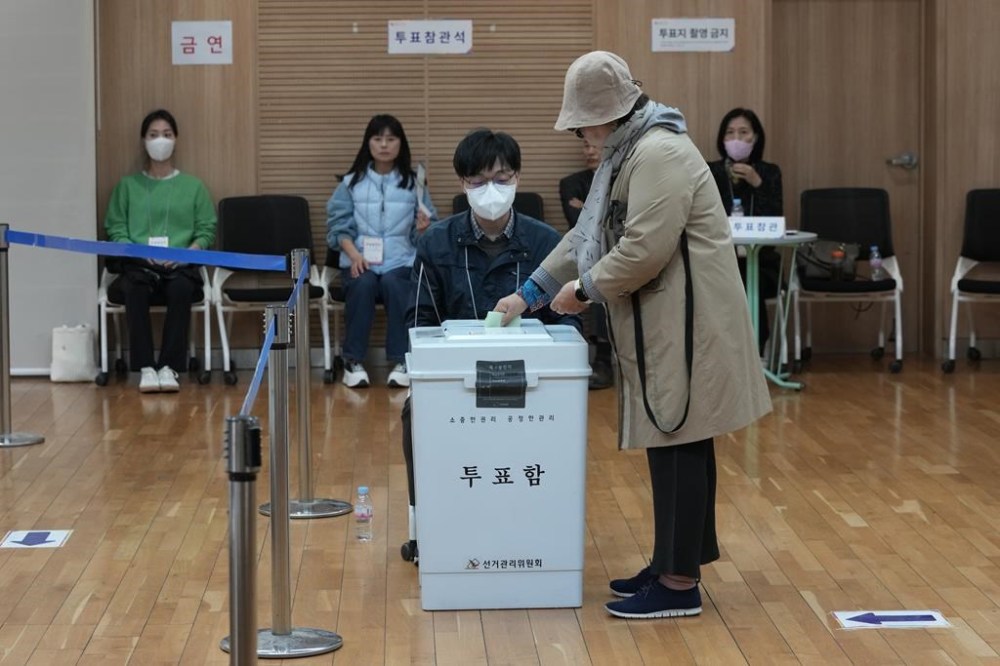 A woman casts her vote for the parliamentary election at a polling station in Seoul, South Korea, Wednesday, April 10, 2024. South Korean President Yoon Suk Yeol faces a crucial referendum Wednesday in a parliamentary election that could determine whether he becomes a lame duck or enjoys a mandate to pursue key policies for his remaining three years in office. (AP Photo/Ahn Young-joon)