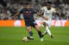 Real Madrid's Vinicius Junior fights for the ball with Manchester City's Rodrigo during the Champions League quarterfinal first leg soccer match between Real Madrid and Manchester City at the Santiago Bernabeu stadium in Madrid, Spain, Tuesday, April 9, 2024. (AP Photo/Manu Fernandez)
